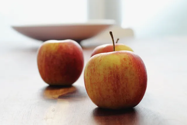 The same apples with more restrained color and separated dark tones in the Fujifilm X100VI Classic Chrome interpretation.